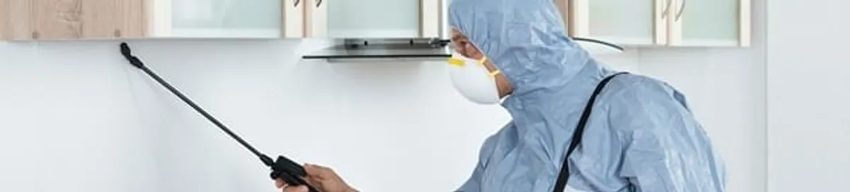 Termite treatment technician applying indoor pest control spray in Los Angeles, CA